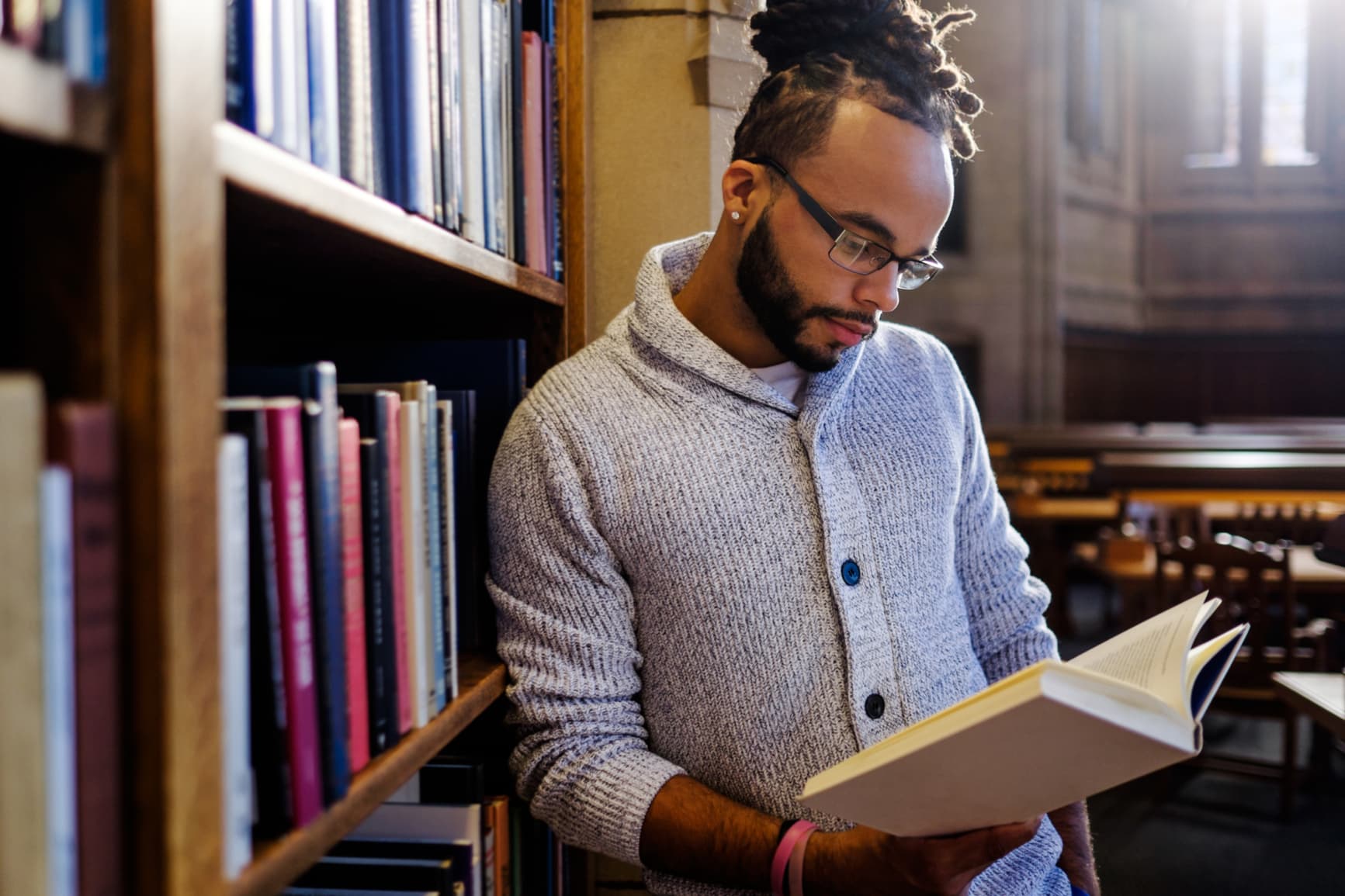 African-American-College-Student-Reading-In-The-Library-should-i-go-to-grad-school