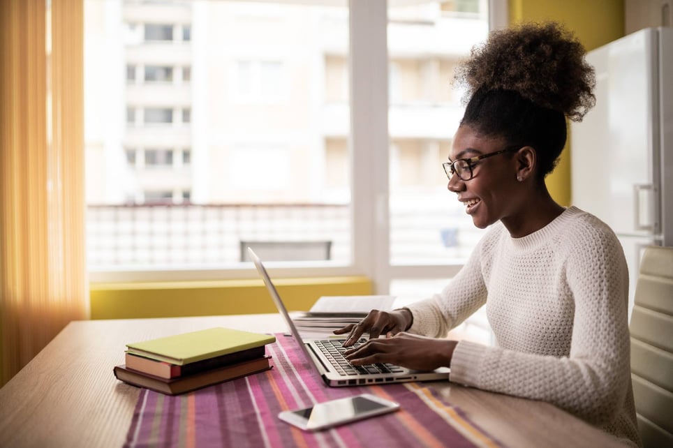 Afro-Woman-sitting-at-home-using-laptop-why-are-you-looking-for-a-new-job