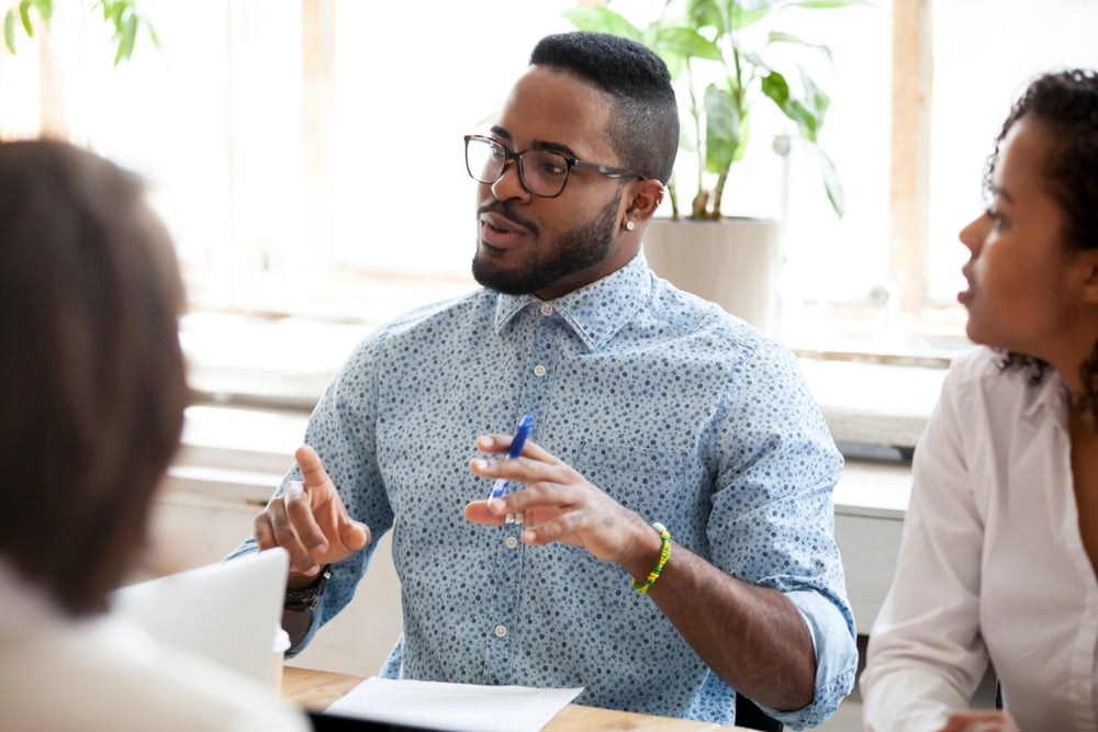 Afroamerican-male-speaking-in-a-meeting-how-to-answer-salary-expectations