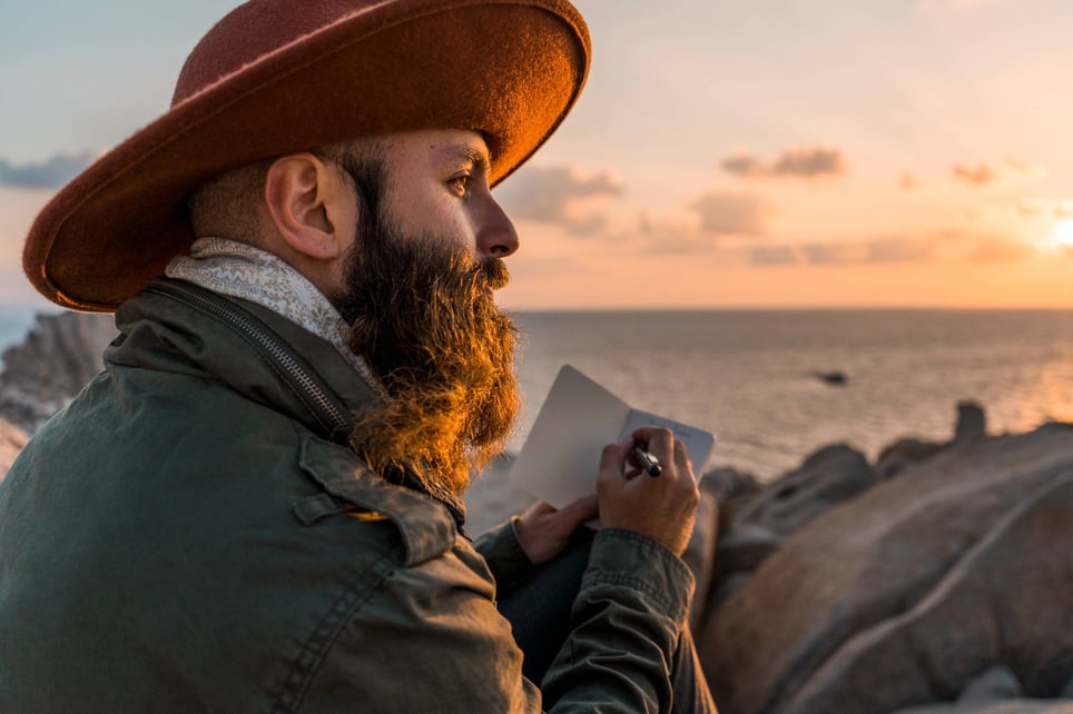 Bearded-man-with-notebook-in-front-of-the-sea-how-to-find-meaning-in-life