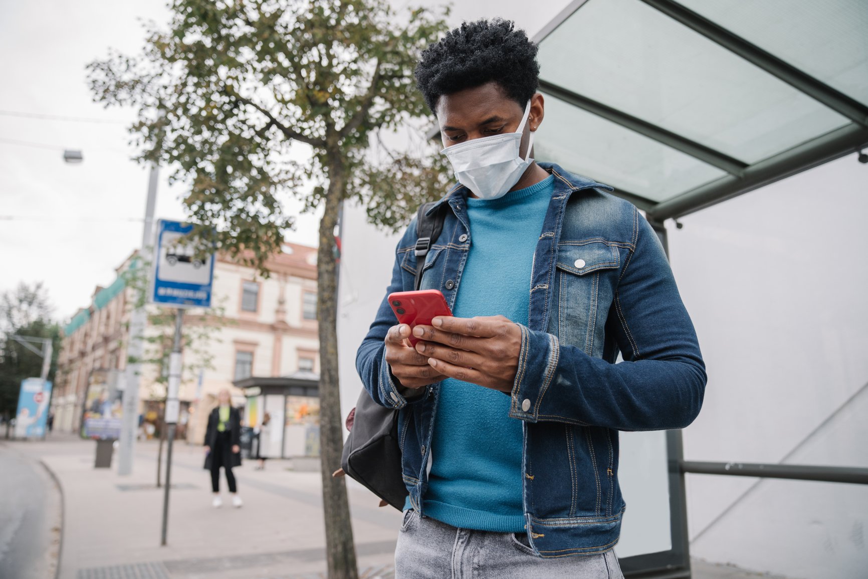 Black-Man-Wearing-Mask-Using-Cellphone-At-Bus-Stop-phone-anxiety