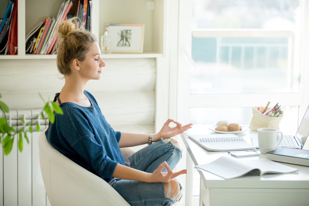 Blonde-woman-meditating-in-front-of-laptop-how-to-be-a-working-mom