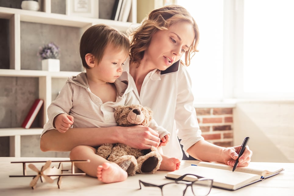 Blonde-woman-with-baby-working-at-desk-how-to-be-a-working-mom