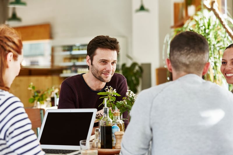 Business-People-In-Discussion-At-Restaurant