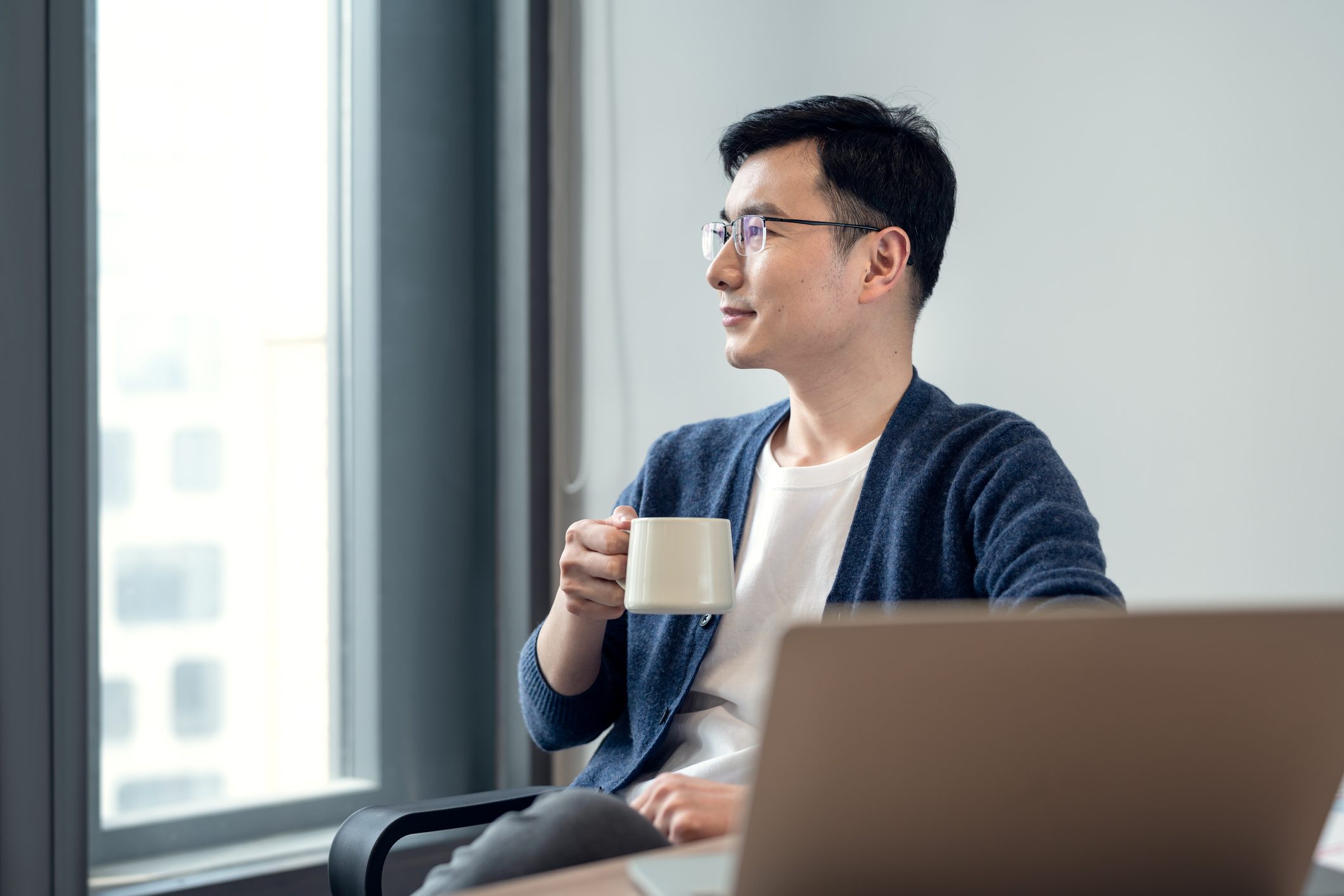 Business-people-sit-in-the-office-and-look-out-of-the-window-at-tea-time-what-are-happy-hormones