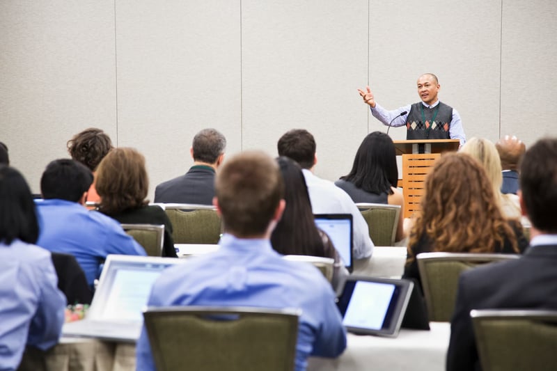 Businessman-speaking-from-a-podium-in-a-conference-1