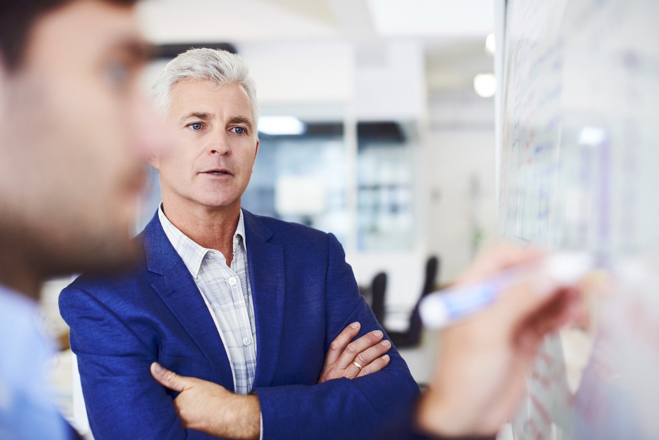 Businessman-with-colleague-writing-on-whiteboard-how-to-increase-attention-span