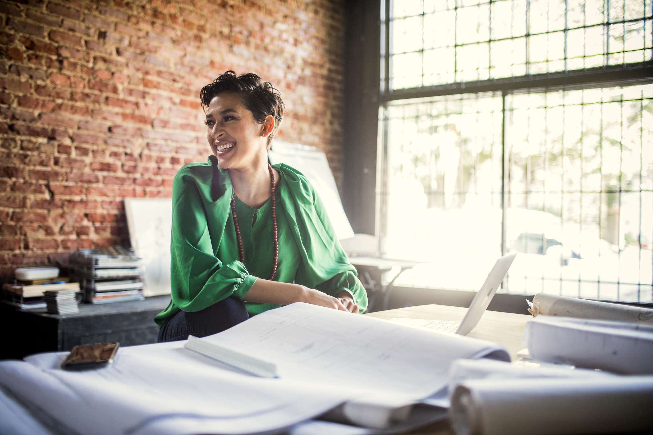 Businesswoman-looking-over-architecture-blueprints-in-office-building-a-network-from-scratch