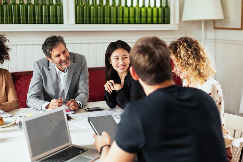 Cheerful-Entrepreneurs-Listening-To-Coworker-1