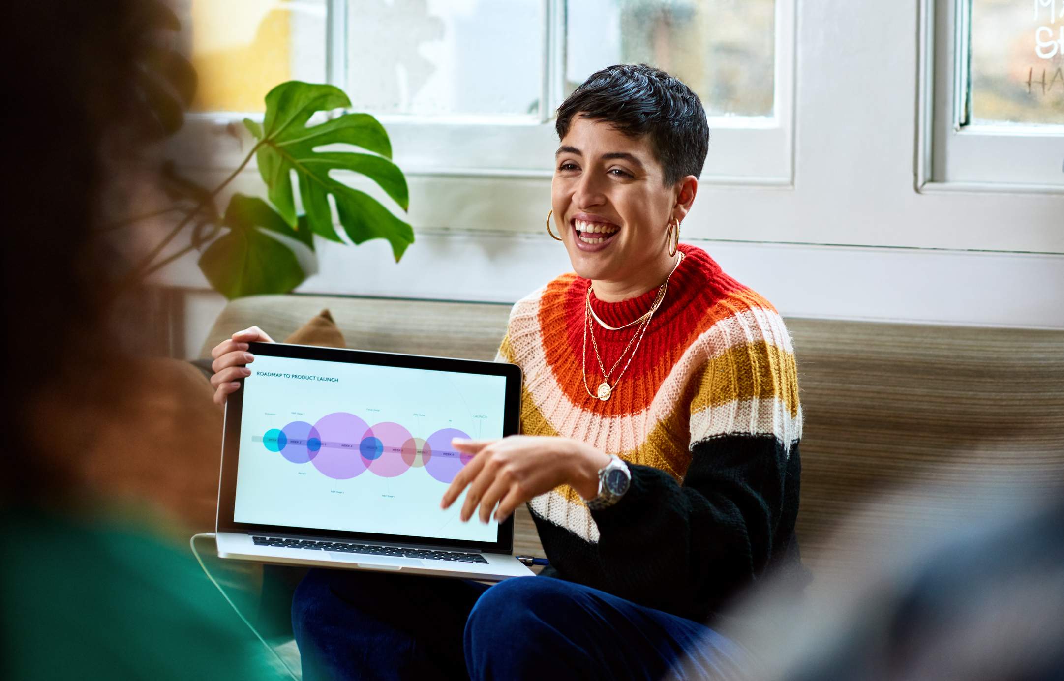 Cheerful-and-happy-young-woman-smiling-at-work-meeting-how-far-back-should-a-resume-go