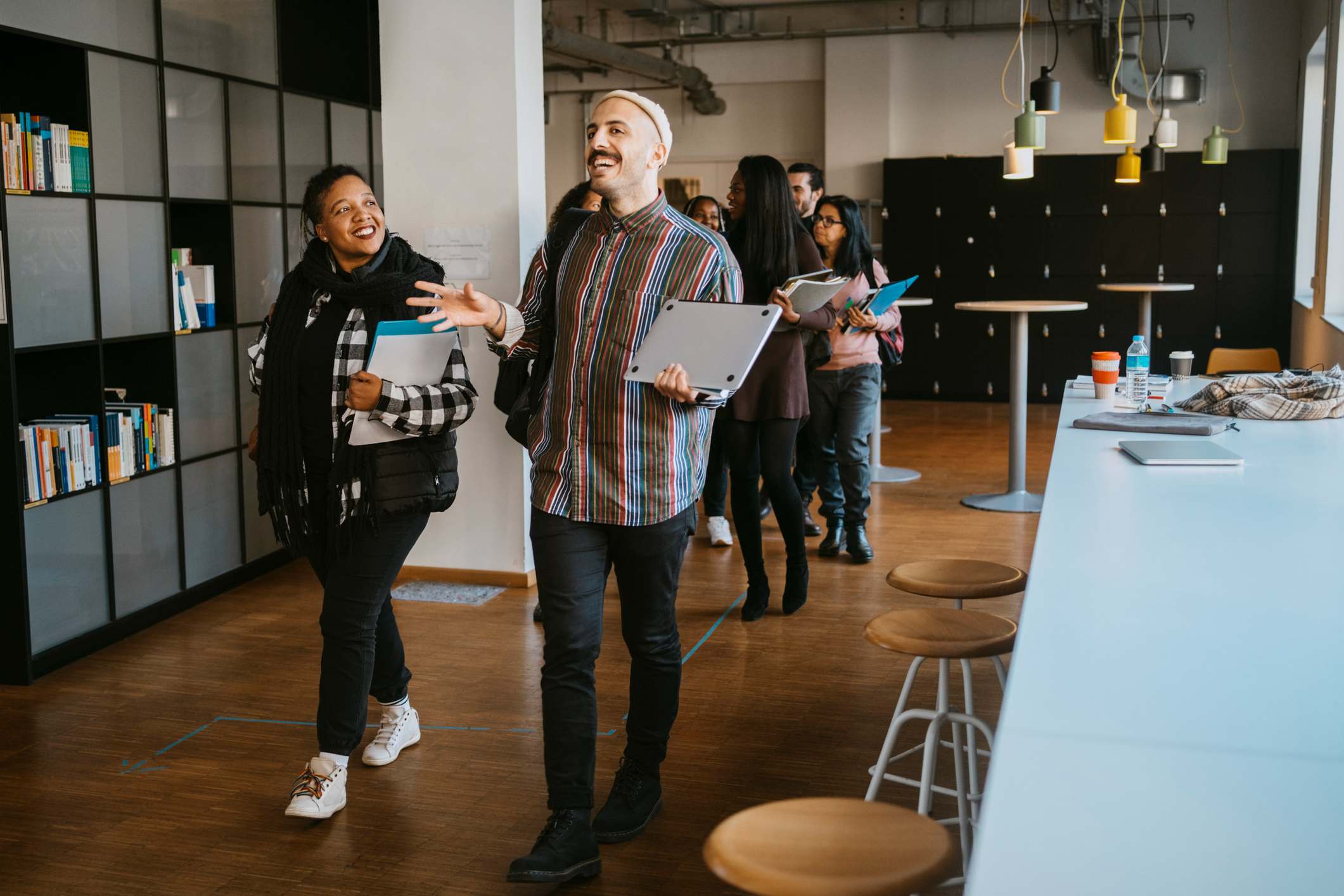 Cheerful-coworkers-talking-while-walking-how-to-set-boundaries-at-work