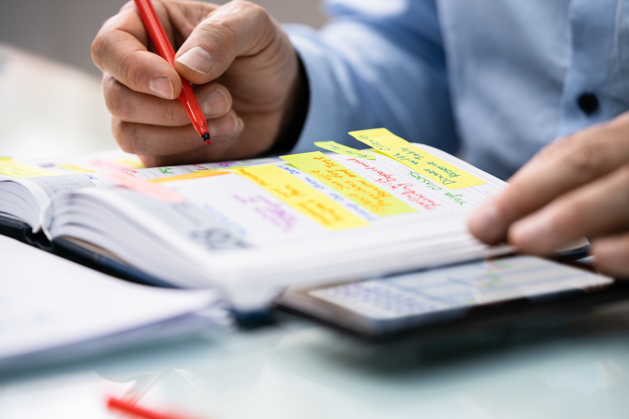 Close-up-of-a-man-writing-in-his-schedule-second-interview-questions