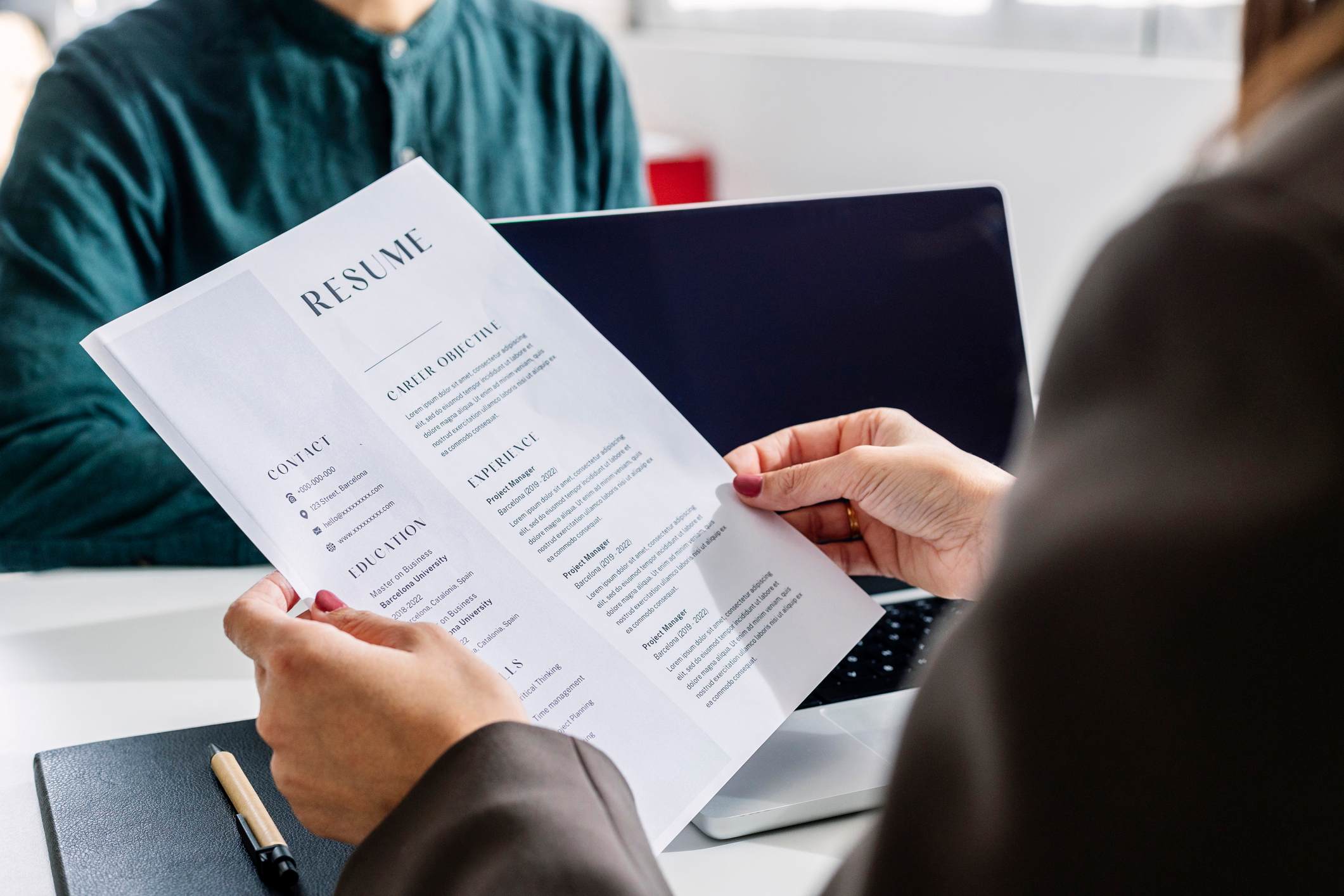 Close-up-of-womans-hand-holding-printed-resume-best-places-to-look-for-jobs