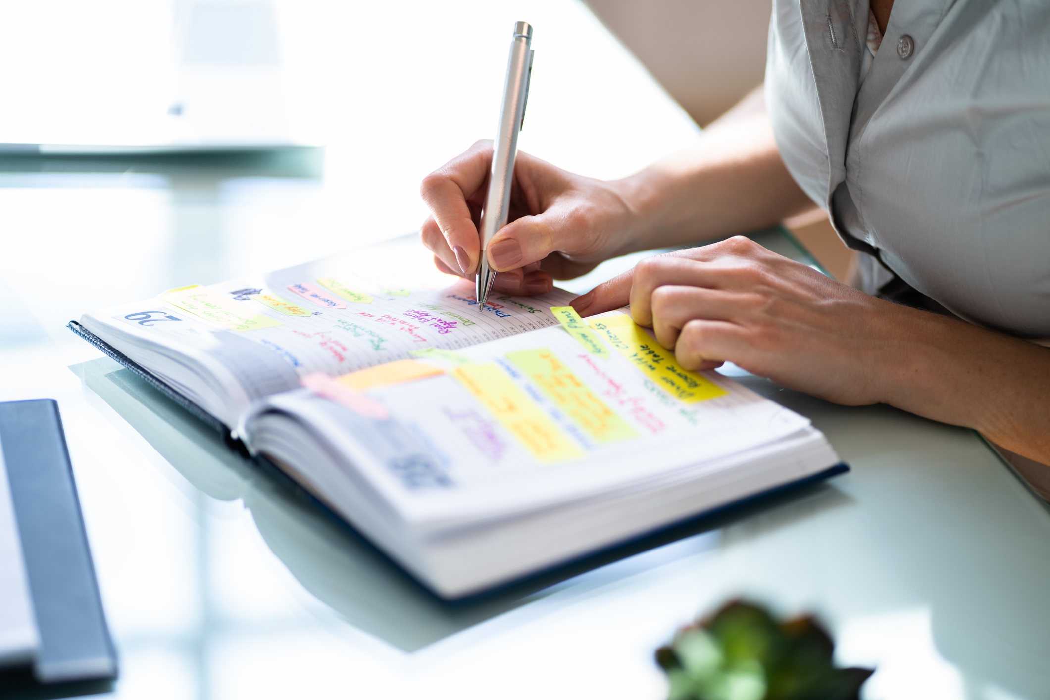 Close-up-of-womans-hand-writing-down-in-her-schedule-protect-your-energy