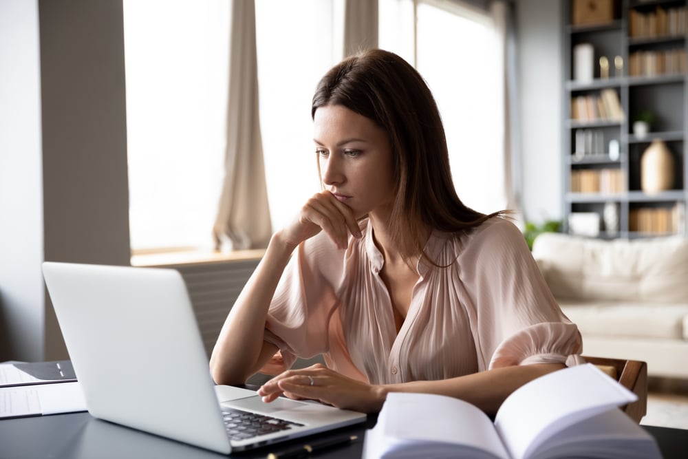 Close-up-serious-focused-woman-looking-at-laptop-overemployed