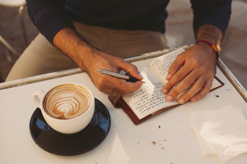 Closeup-on-a-man-writing-in-a-journal