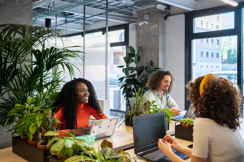 Colleagues-Chatting-Sitting-Around-The-Table-At-Work-what-is-teamwork