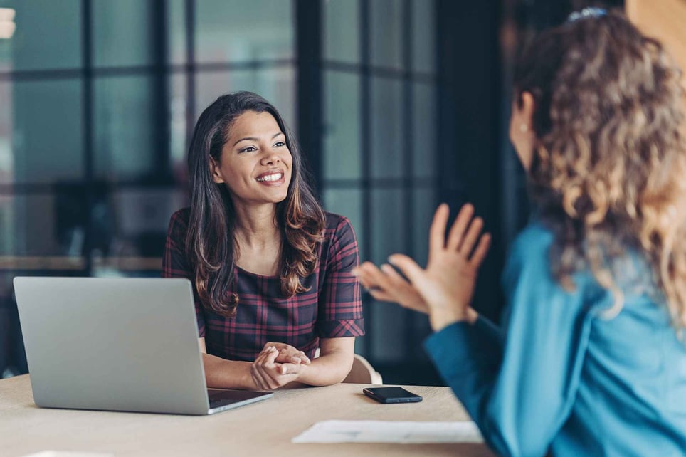 Colleagues-discussing-business-at-job-interview-signs-of-good-interview