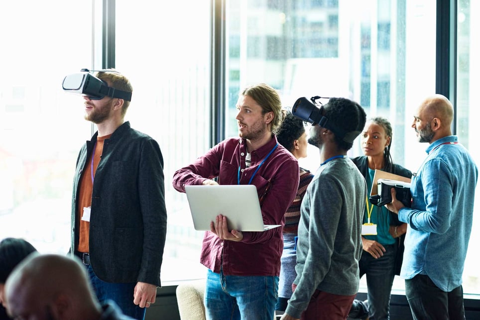 Collegues-at-office-using-laptop-and-trying-virtual-reality-what-is-disruptive-innovation