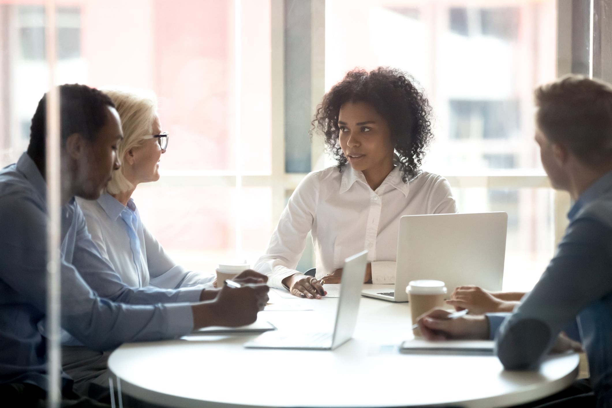 Concerned-woman-with-collegues-at-a-meeting-passive-aggressive-boss