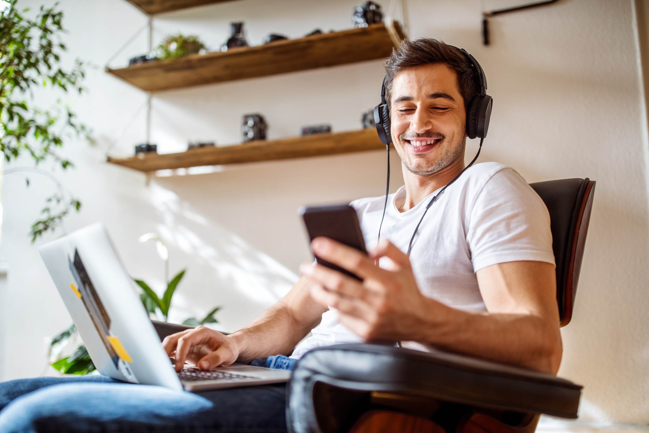 Confident-man-smiling-while-listening-to-recordings-with-headphones-affirmations-for-imposter-syndrome