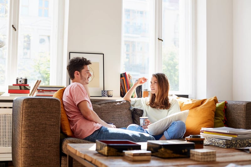 Couple-Talking-While-Sitting-On-Sofa