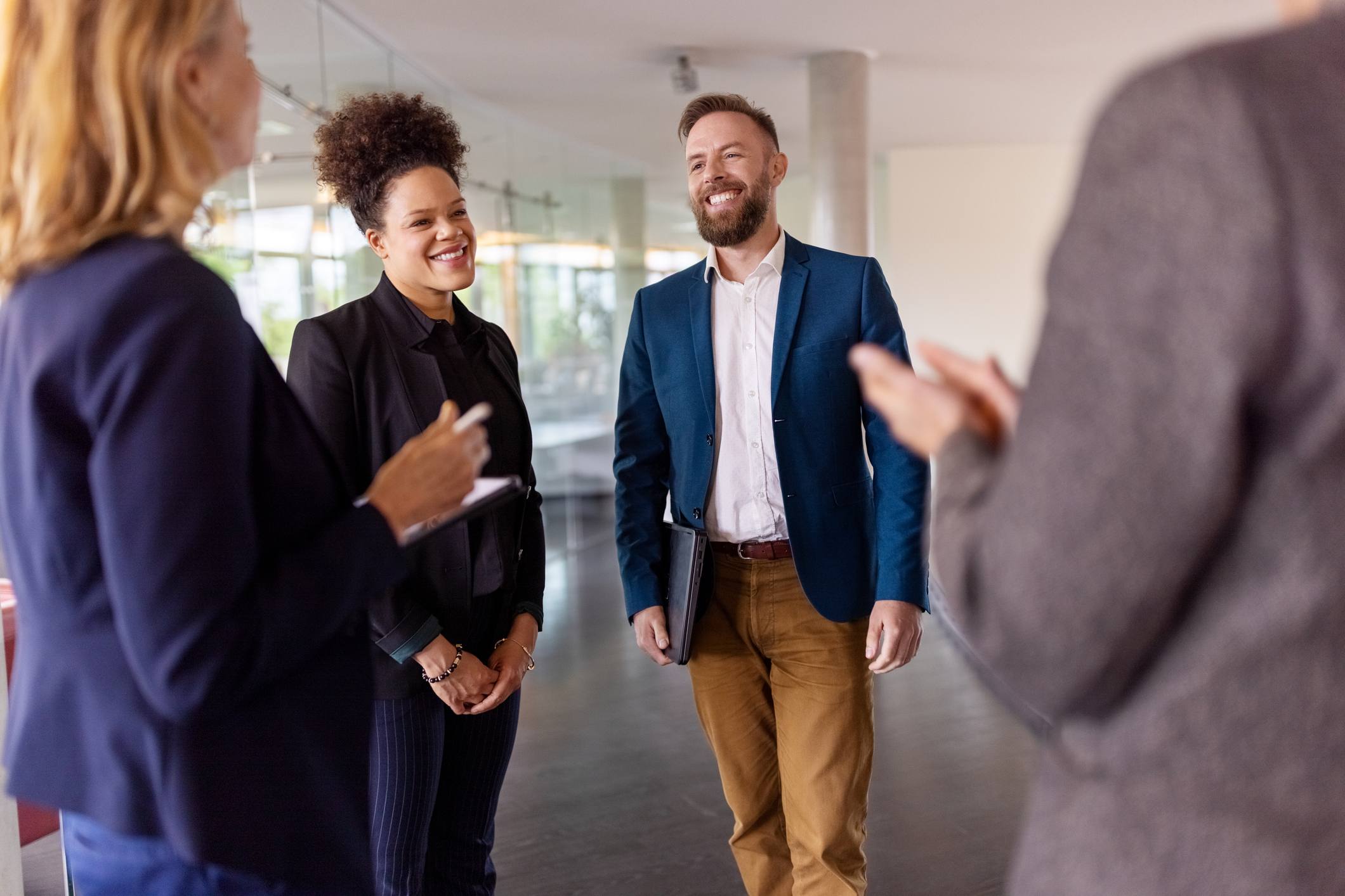 Coworkers-cheering-and-congratulating-man-at-office-internal-interview-questions