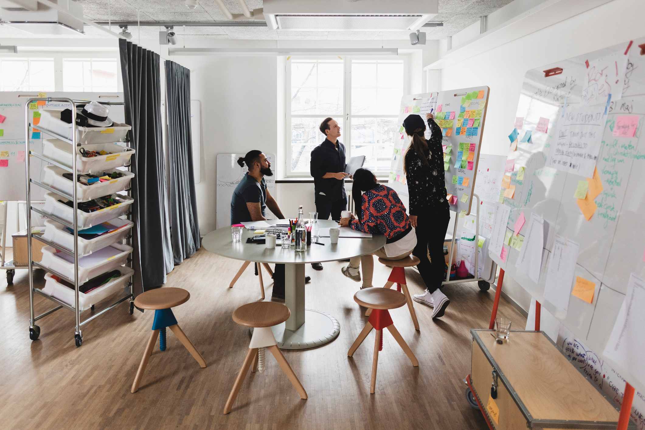 Coworkers-looking-at-white-board-and-solving-problem-together-decision-making-style