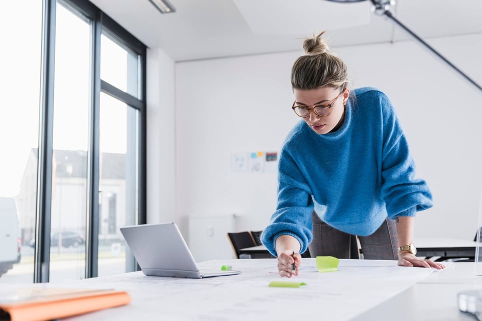 Creative-and-concentrated-woman-writing-on-paper-what-is-lateral-thinking