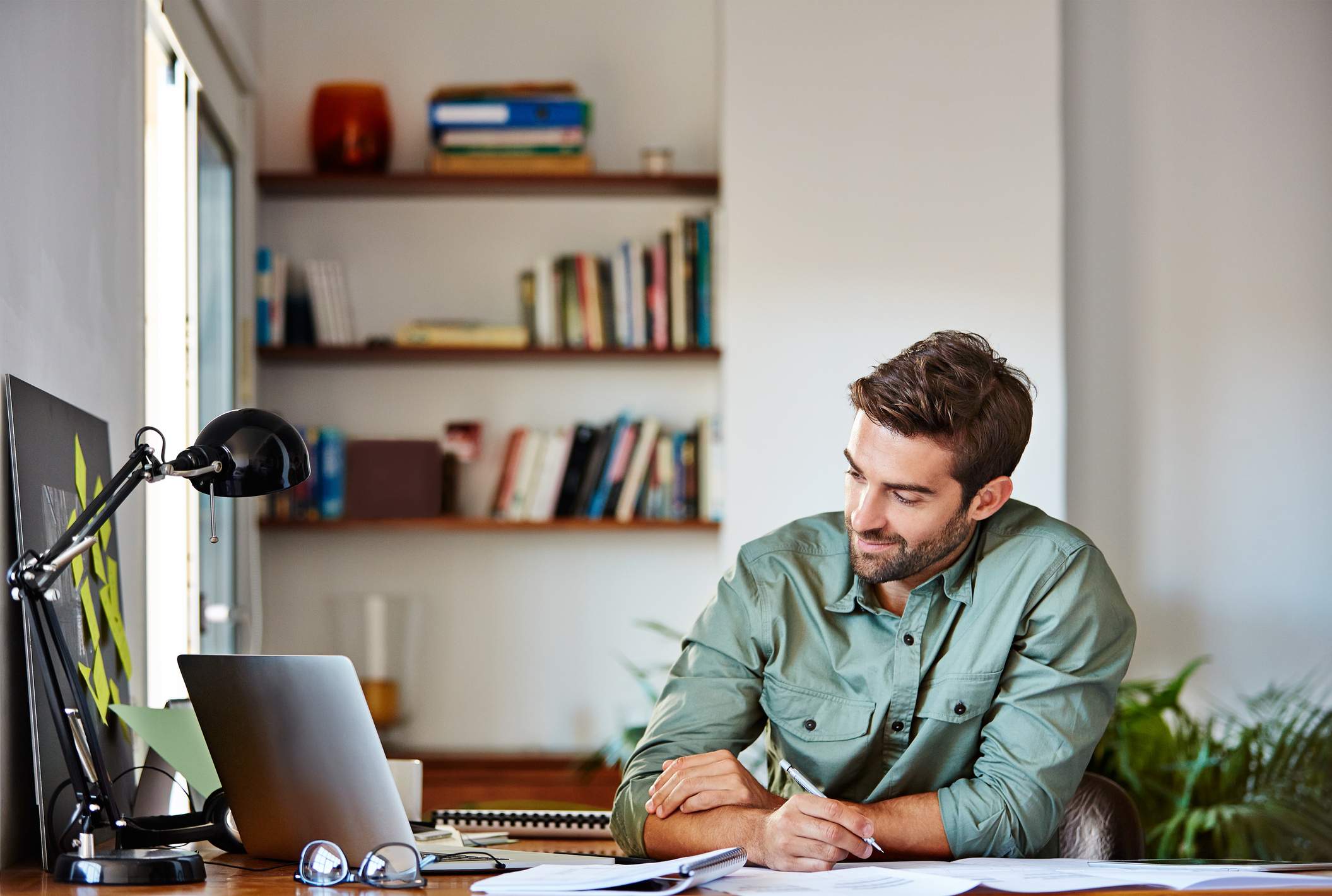 Cropped-shot-of-a-handsome-young-man-making-notes-while-working-at-home-functional-resume