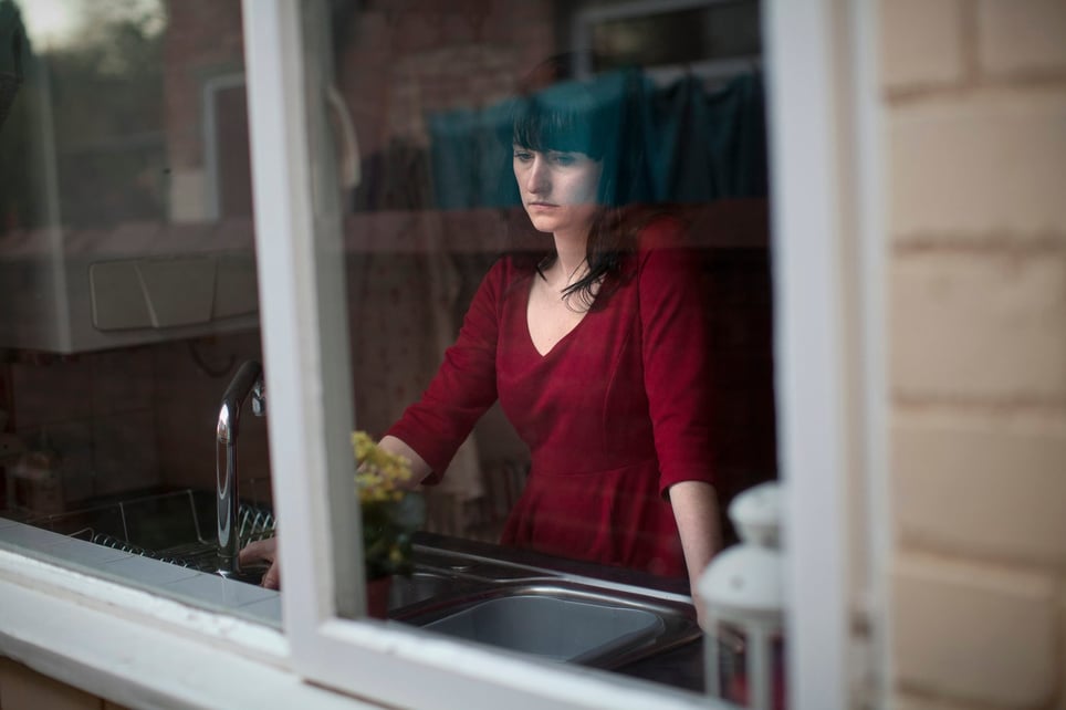 Disappointed-woman-standing-in-kitchen-purpose-of-fear