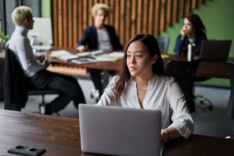 Employee-Using-Laptop-In-Workplace-how-to-fire-someone-nicely