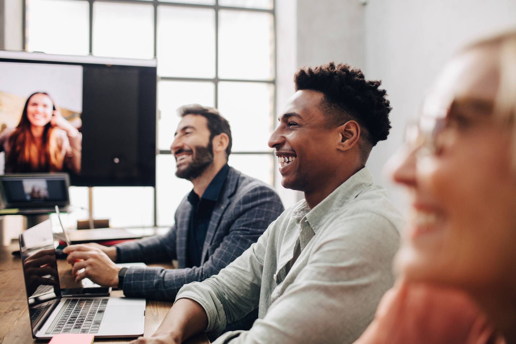 Employee-smiling-amongst-coworkers-at-office-team-collaboration