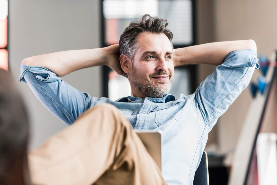 Empowered-man-sitting-at-his-office-how-to-improve-self-determination