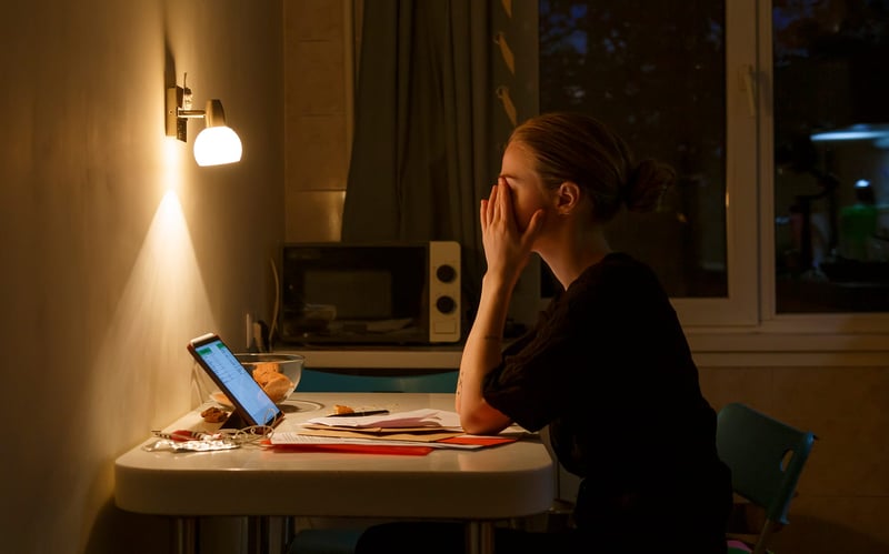 Exhausted-Female-Working-In-Kitchen-overworked-symptoms