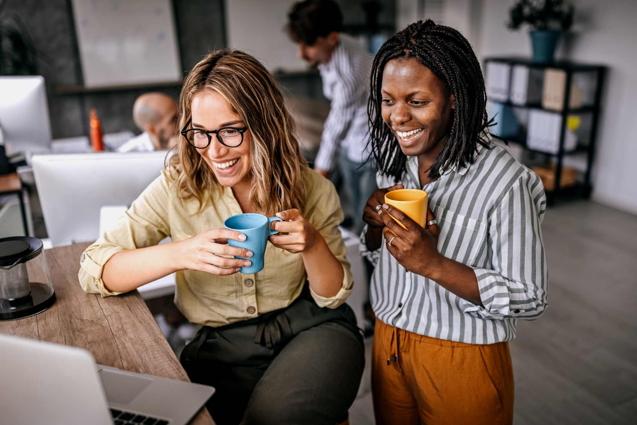 Female-coworkers-looking-at-laptop-at-office-off-the-job-training