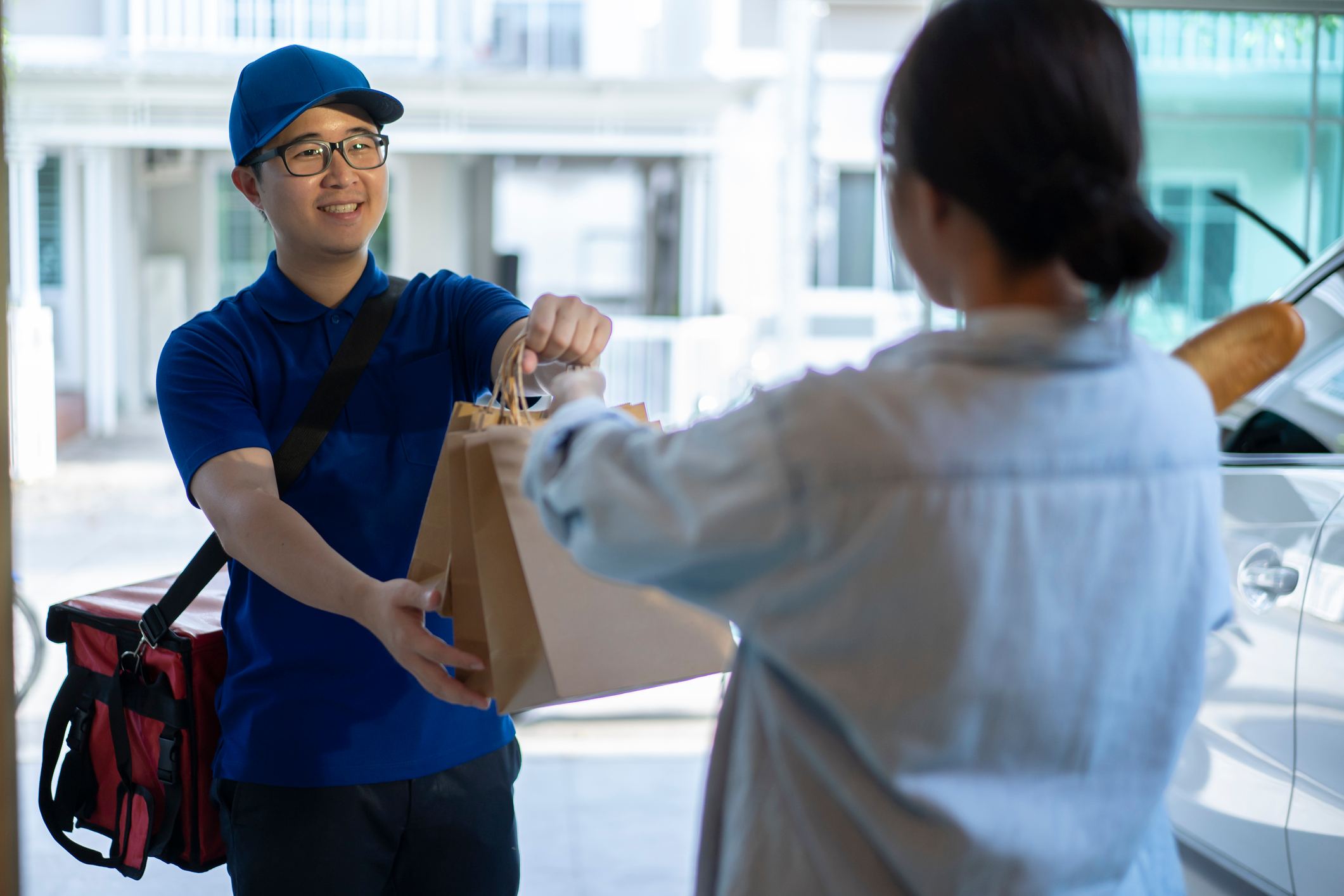 Food-delivery-man-giving-package-to-woman-types-of-innovation