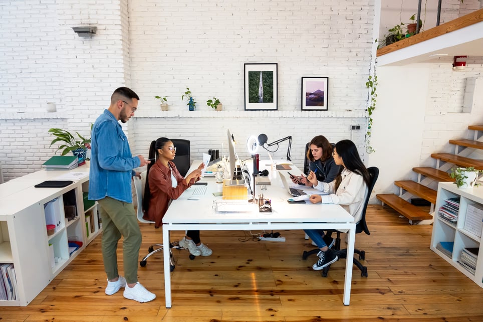 Four-people-immersed-in-work-in-office-toxic-work-environment