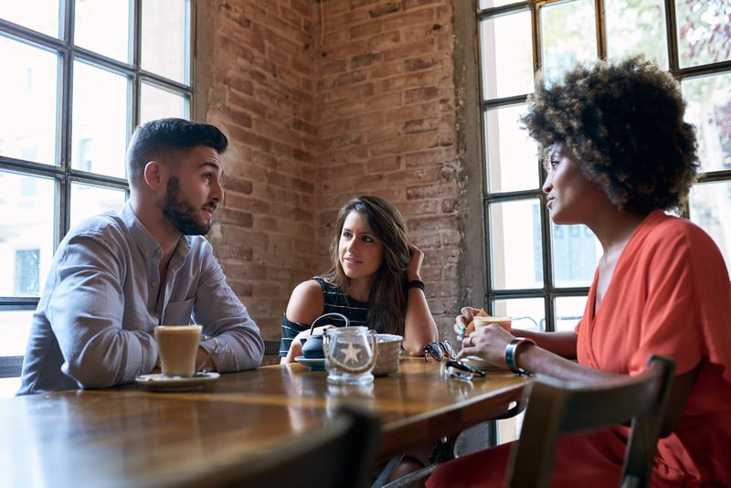 Group-Of-Friends-Having-Lunch-In-Cafe