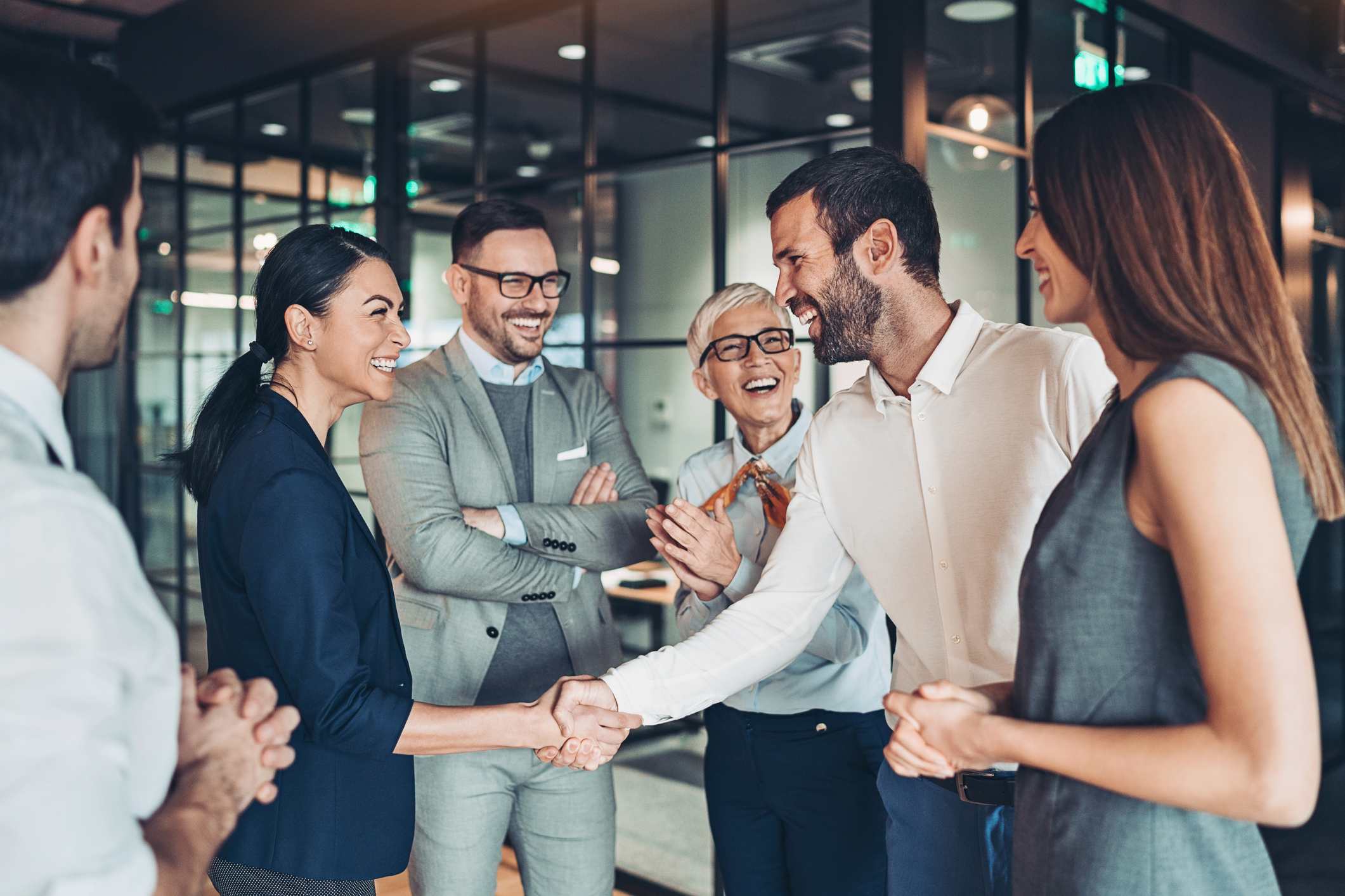 Group-of-business-persons-handshake-in-the-office-goodbye-email-to-coworkers