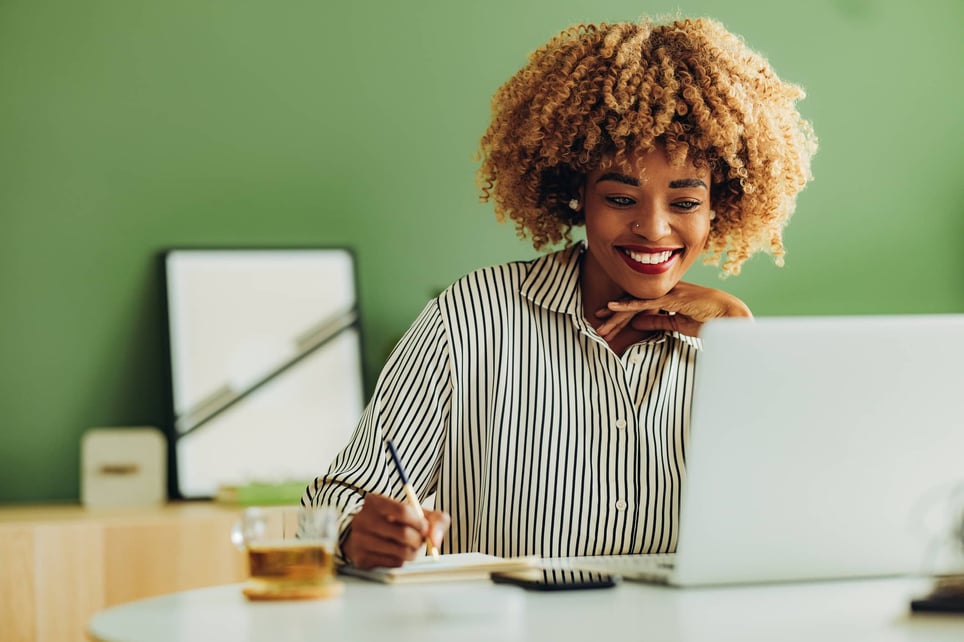 Happy-businesswoman-working-at-her-office-how-to-be-content-with-life