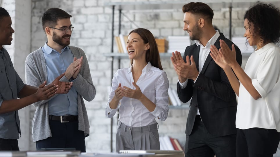 Happy-employees-congratulating-a-businesswoman-how-to-praise-someone-professionally