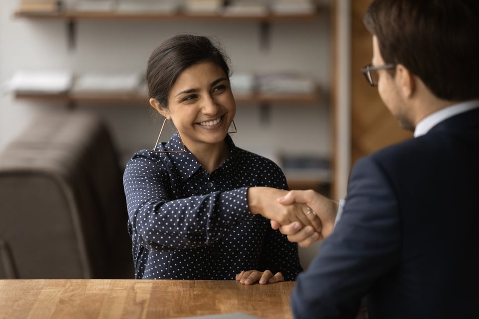 Happy-employer-HR-manager-shaking-hands-with-indian-job-overemployed