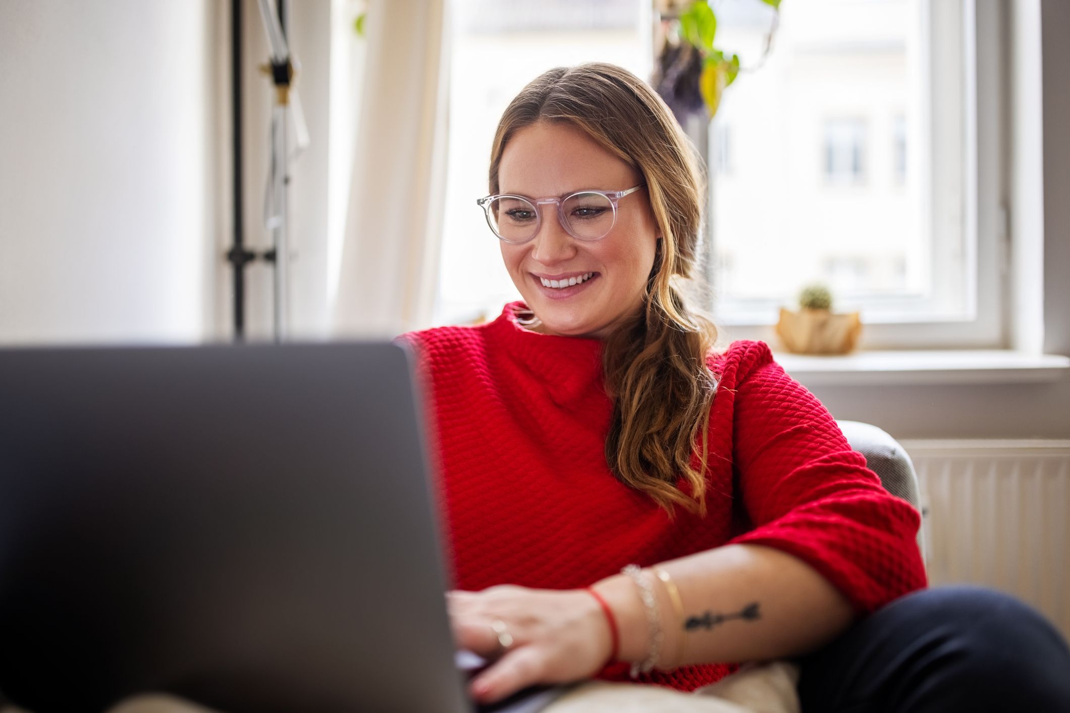 Happy-woman-working-on-laptop-at-home-how-to-deal-with-career-disappointment