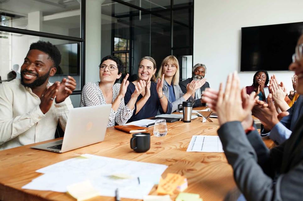 Happy-work-team-cheering-and-celebrating-at-meeting-team-collaboration