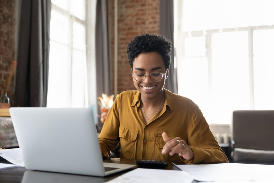 Happy-young-Afro-American-entrepreneur-woman-in-glasses-counting-profit-what-is-commission-pay