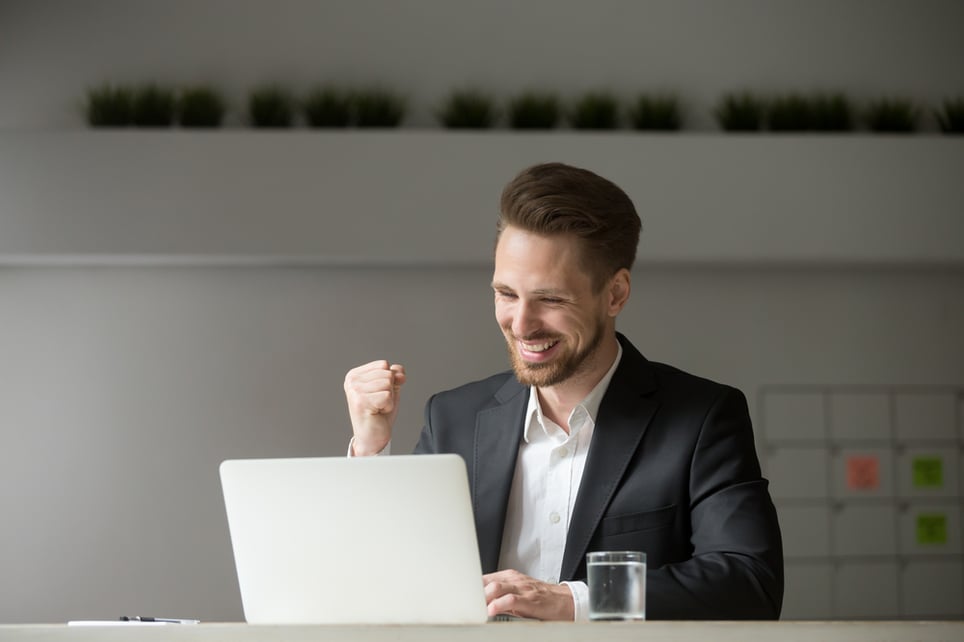 Happy-young-businessman-in-suit-looking-at-laptop-endurance-vs-resilience