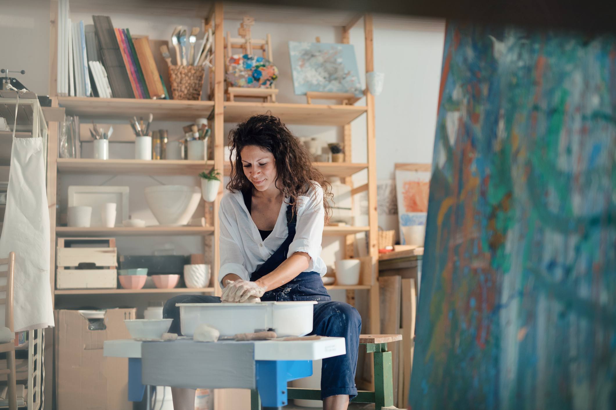 Happy-young-woman-making-a-ceramic-pot-in-a-workshop-career-statement