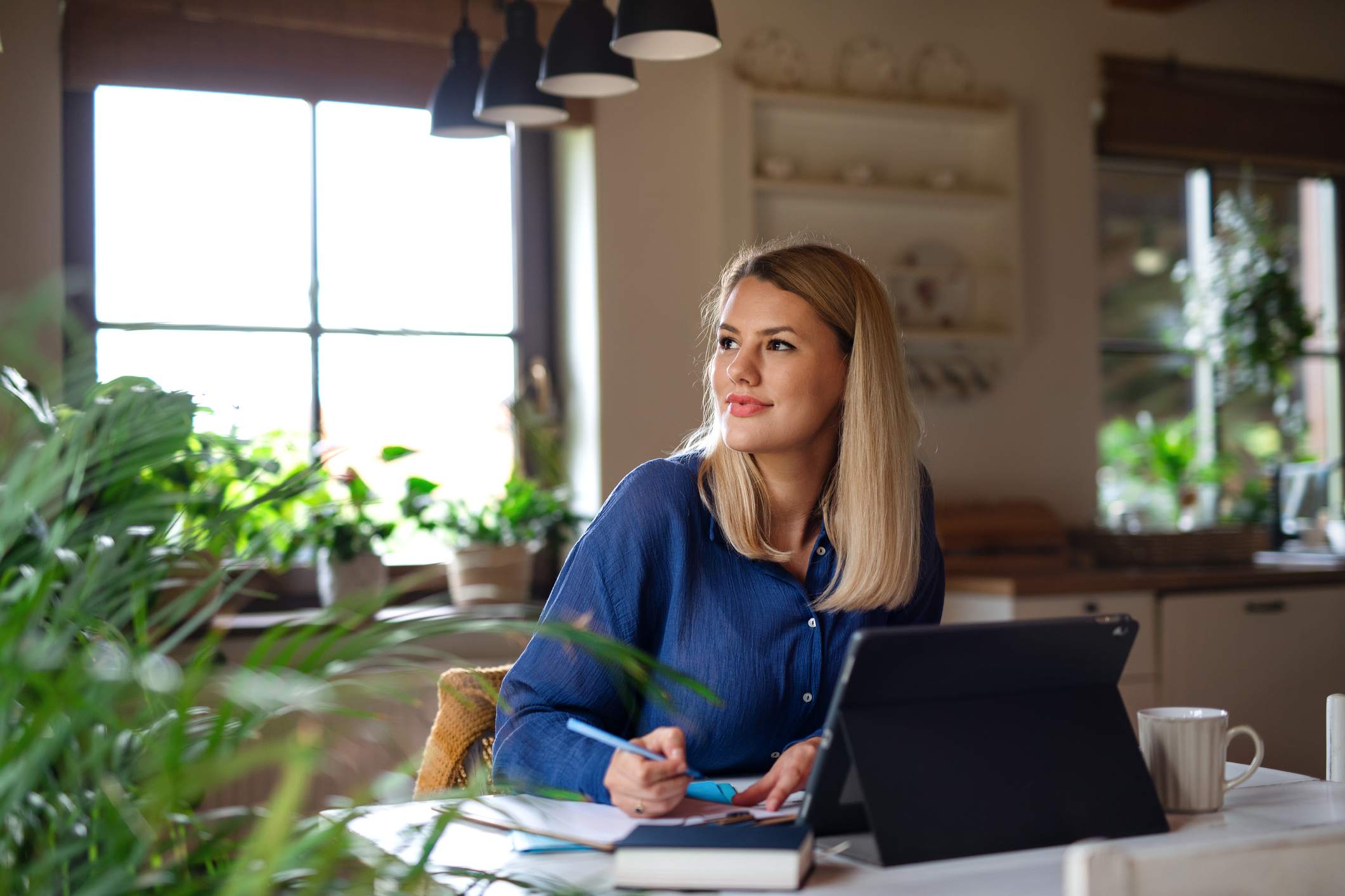 Happy-young-woman-writing-and-studying-at-home-goodbye-email-to-coworkers