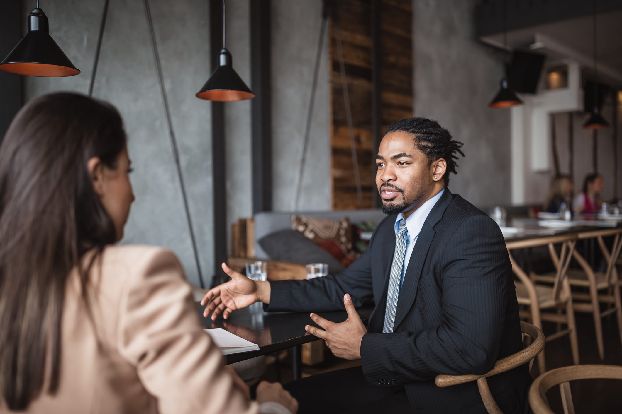 Hiring-manager-talking-to-woman-looking-for-job-different-type-of-resumes